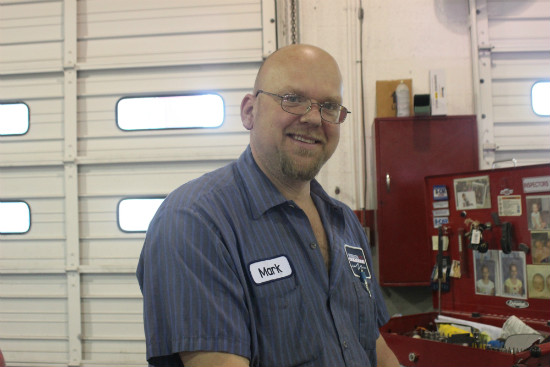 Mark McClain prepares his work desk to fix some automobiles